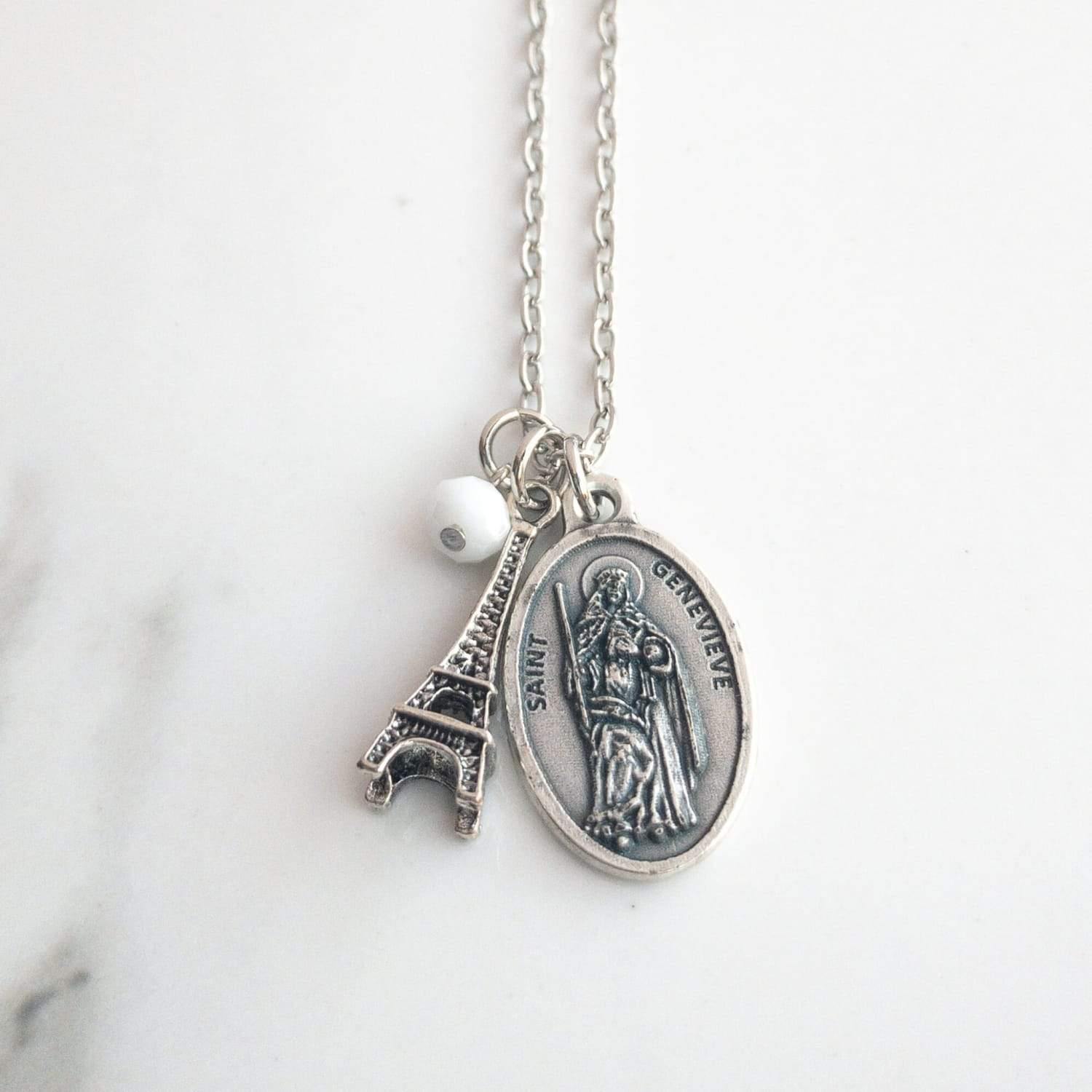 Sagely Sparrow St. Genevieve Necklace on a white background with black marbling