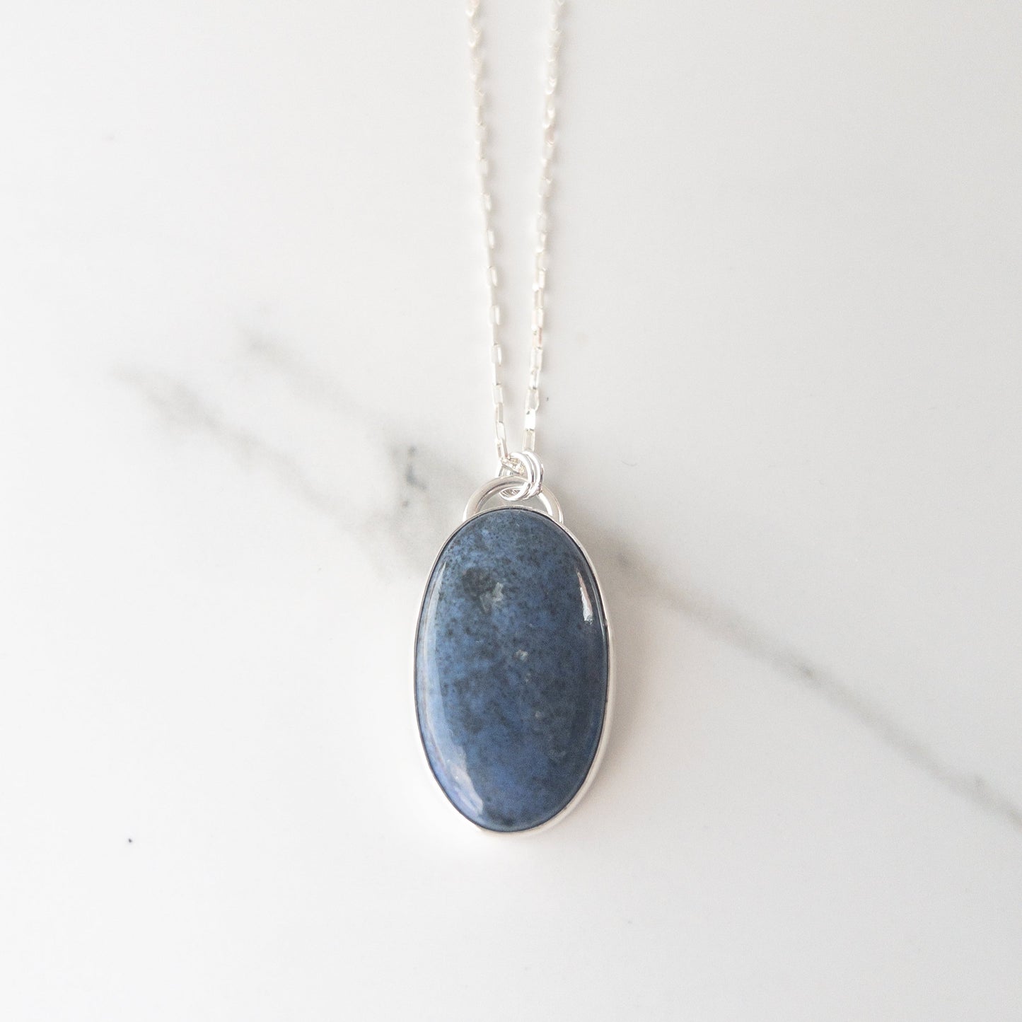 Sterling silver necklace with deep blue cabochon and hidden crucifix cutout on back, displayed in leatherette box – Catholic statement jewelry