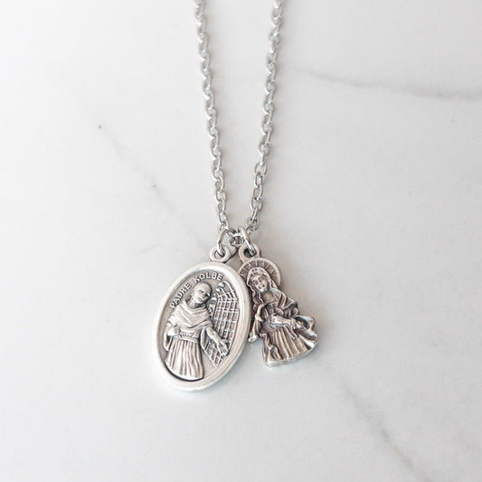 Handmade Catholic necklace by Sagely Sparrow featuring a silver-tone Saint Maximilian Kolbe medal paired with an Immaculate Heart of Mary charm and red glass bead, on a silver chain. Meaningful religious gift for Catholics, Confirmation, or Marian devotion.