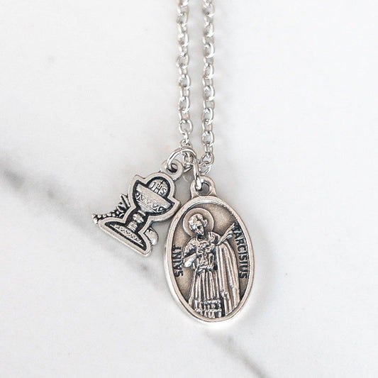 Handmade necklace featuring a silver-tone Saint Tarcisius medal, patron of altar servers, paired with a small silver-tone chalice charm. The charms hang from a nickel-free chain, available in two lengths, made by Sagely Sparrow.