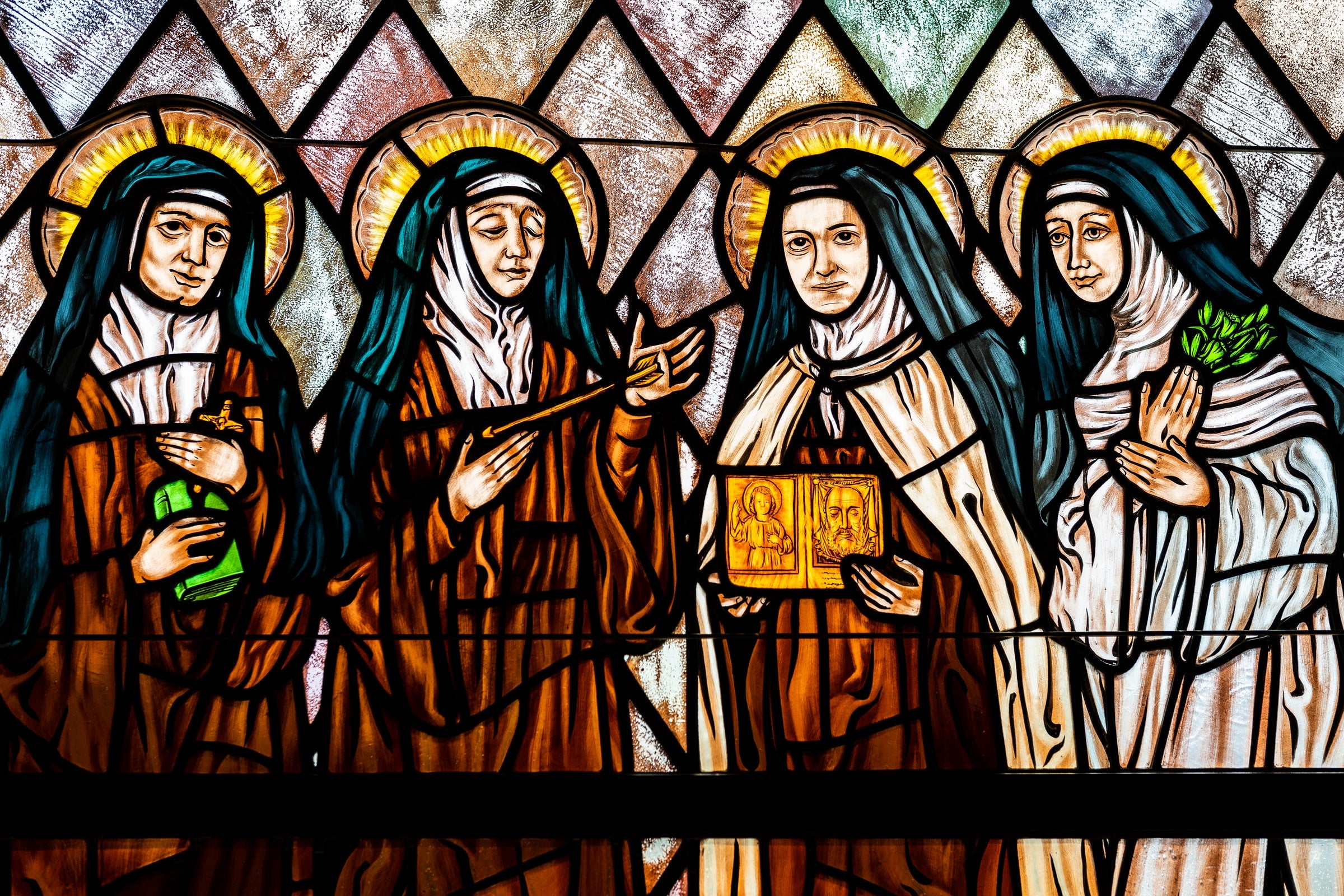 Image by Nick Castelli - A stained glass window depicting four women Doctors of the Church: St. Teresa Benedicta, St. Teresa of Avila, St. Therese of Lisieux, and St. Catherine of Sienna at St. Therese of Lisieux R.C. Church in Montauk, NY