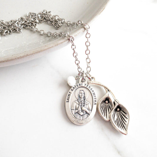 Handmade Catholic necklace by Sagely Sparrow featuring a silver-tone Saint Kateri Tekakwitha medal with a small turquoise bead charm on a silver chain. Thoughtful gift for Catholic women, Confirmation, or those devoted to the Lily of the Mohawks.