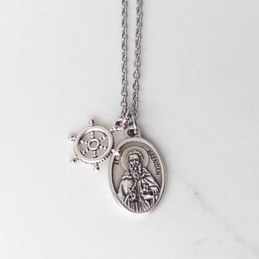 St. Brendan saint medal necklace with a ship's wheel charm on a stainless steel chain