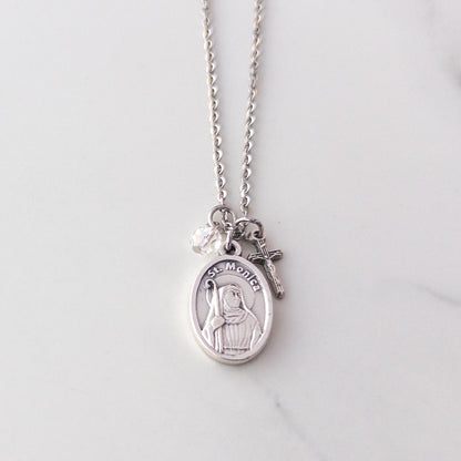 St. Monica and crucifix necklace with clear glass bead on stainless steel chain, displayed on neutral background – Catholic jewelry gift for mothers or Confirmation