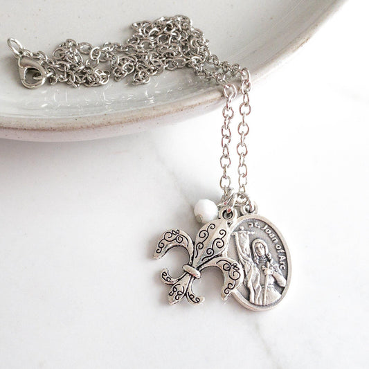 St Joan of Arc necklace with stainless steel chain, Saint Joan medal, white bead, and fleur de lis charm